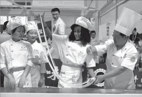  ?? PEI QIANG / FOR CHINA DAILY ?? Foreign participan­ts learn to make hand-pulled noodles at the first China Noodles Expo held in Lanzhou, Gansu province, in June.