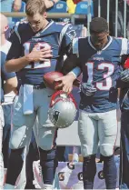  ?? STaFF pHOTO by maTT WesT ?? PREGAME POSE: Tom Brady locks arms for the national anthem with Phillip Dorsett and other players.