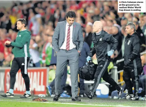  ??  ?? > Chris Coleman stares at the ground as he realises Wales’ World Cup dream is ending