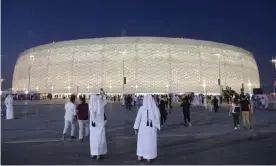  ?? Photograph: Karim Jaafar/AFP/Getty Images ?? Fans gather outside the Al Thumama Stadium in Doha. The stadium is one of eight which will host the World Cup in 12 months’ time.