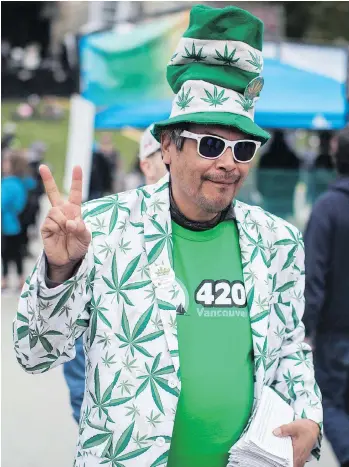  ?? DARRYL DYCK/THE CANADIAN PRESS FILES ?? A man joins the 4/20 cannabis celebratio­n, in Vancouver on April 20. The Senate has amended the Cannabis Act, worried about the effect of promotiona­l products on youth.
