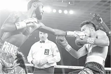  ?? TOP RANK PHOTO/MIKEY WILLIAMS ?? US boxer ‘Prince’ Albert Bell lands a solid left straight to the face of Sanman Gym’s Mark ‘Machete’ Bernaldez during their bout yesterday at the MGM Grand in Las Vegas. Bell won by unanimous decision.