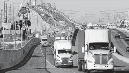  ?? Carolyn Cole / Tribune News Service ?? Trucks move across Terminal Island, shared by the ports of Los Angeles and Long Beach in California. Many economists and analysts pin a perceived truck driver shortage on lack of retention, saying the trucking industry isn’t doing enough to keep drivers.