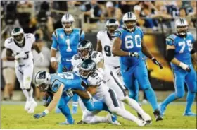  ?? BOB LEVERONE — THE ASSOCIATED PRESS ?? Carolina Panthers’ Christian McCaffrey (22) prepares to hit the turf as Philadelph­ia Eagles’ Mychal Kendricks (95) and Chris Long (56) team up to make the tackle during the second half of an NFL football game in Charlotte, N.C., Thursday. The Eagles...