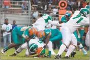  ?? STAFF PHOTO BY MICHAEL REID ?? St. Charles quarterbac­k Marlon Brown is sacked by Westlake’s Rexford Edlen, left, and John Barnes in Friday night’s contest. Westlake shut out St. Charles, 22-0.