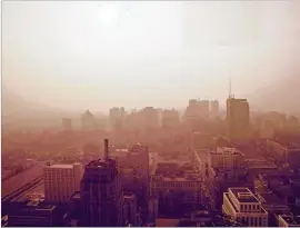  ?? NATIONAL ARCHIVES VIA NEW YORK TIMES ?? The Philadelph­ia city center shrouded in smog at sunset in 1973. Nearly 50 years ago, environmen­tal disasters spurred a popular movement that culminated in new protection­s and helped to inspire the first Earth Day.U.S.