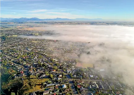  ?? PHOTO: MYTCHALL BRANSGROVE/FAIRFAX NZ ?? A thick blanket of fog creeps over Timaru on Tuesday morning, before giving way to a sunny summer day.