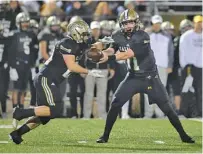  ?? PHOTO BY MARK GILLILAND ?? Calhoun quarterbac­k Gavin Gray hands off to Zack Fuller during the Yellow Jackets’ playoff win against Lovett last week.