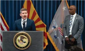  ?? ?? The head of the justice department's election threats taskforce, John D Keller, speaks as FBI Phoenix field office special agent in charge, Akil Davis, listens during a press conference on Monday in Phoenix, Arizona. Photograph: Rebecca Noble/Getty Images