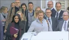  ?? Associated Press ?? In this image made from video, Britain’s Prince Harry, center right, and his wife Meghan Markle, left, Duke and Duchess of Sussex, approach a car at an airport in Sydney on Monday. Kensington Palace says the couple are expecting a child in the spring.