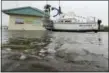  ?? AP PHOTO/DAVID J. PHILLIP ?? A sailboat sits next to a dog grooming business in a flooded area in the aftermath of Hurricane Harvey Saturday, Aug. 26, 2017, in Palacios, Texas.