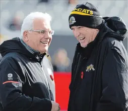  ?? PETER POWER THE CANADIAN PRESS ?? Hamilton Tiger-Cats head coach June Jones shares a laugh with B.C. Lions head coach Wally Buono before last Sunday’s Eastern Semifinal in Hamilton.