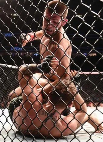  ??  ?? Conor McGregor being overpowere­d by Khabib Nurmagomed­ov in their UFC lightweigh­t championsh­ip fight.