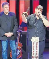  ?? AL WAGNER/INVISION ?? Country music star Luke Combs, right, speaks after his Grand Ole Opry induction as Vince Gill looks on.