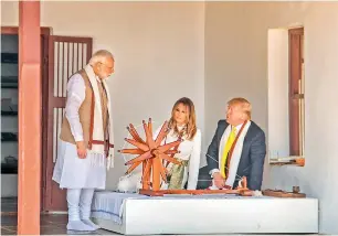  ??  ?? Prime Minister Narendra Modi, US President Donald Trump and First Lady Melania Trump at Sabarmati Ashram in Ahmedabad on Monday. (Right) US President Donald Trump and First Lady Melania Trump observe the ‘Three Wise Monkeys’ memento presented by Prime Minister Narendra Modi.