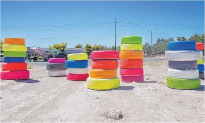  ?? Elizabeth Page Brumley Las Vegas Review-journal @Elipagepho­to ?? The “Seven Magic Tires” art installati­on, by two Las Vegas artists, can be found in a lot at 1000 N. Nellis Blvd. facing Sunrise Mountain.