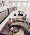  ??  ?? The carpeted staircases, above, feature wood and metal banisters. Left, the focal point of the great room is a cosy, tile-faced fireplace.