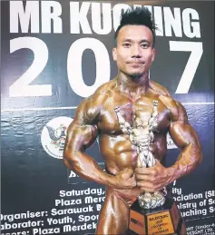  ??  ?? Joseph Ladi poses after winning the Mr Kuching title.