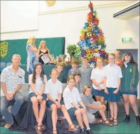  ??  ?? Teachers Peter Besley and his wife, Amanda Besley (back right) with students who made flowers for the winning upcycled Christmas tree.