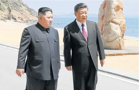  ?? Reuters ?? Seaside stroll: Chinese President Xi Jinping and North Korean leader Kim Jong-un meet in Dalian, Liaoning province, China, in this picture released by Xinhua on Tuesday. Beijing is keen to avoid being left out in the cold in the wake of Kim’s summit in...