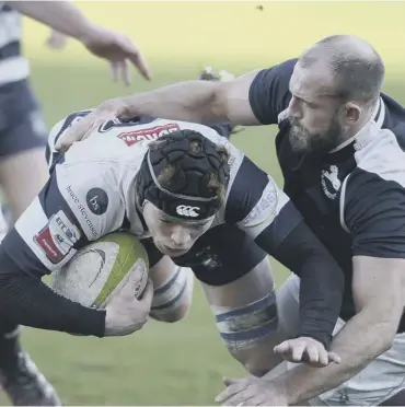  ??  ?? 0 Co-ops flanker Rory Drummond tackles the Heriot’s back row forward Martin Hughes.