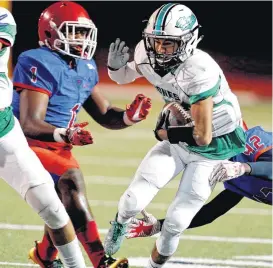  ?? [PHOTO BY STEVE SISNEY, THE OKLAHOMAN] ?? Jones’ Callen Houston carries the ball running between John Marshall defenders Keyshawn Shells, left and Gary Norris during the Class 3A semifinal football game as Jones beat John Marshall 36-29 on Friday in Moore