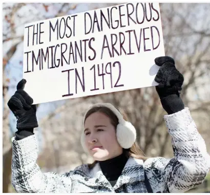  ??  ?? A demonstrat­or holds a sign near the White House to protest the US travel ban on six Muslim countries on Saturday in Washington. (AFP)