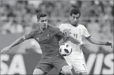  ?? PAVEL GOLOVKIN/AP PHOTO ?? Portugal’s Andre Silva, left, Iran’s Vahid Amiri challenge for the ball during the group B World Cup match on Monday at Saransk, Russia.