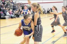  ?? ERIC BOURQUE ?? Aurora Nickerson has the ball for Shelburne during the first game of the Steve Brewer tournament in Yarmouth. Rayanne Oakley is guarding the ball for Yarmouth.