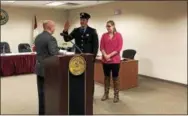  ?? NICHOLAS BUONANNO — NBUONANNO@TROYRECORD.COM ?? Firefighte­r Kyle Miller stands with his wife, Emily, as Troy Mayor Patrick Madden swears him in to become a lieutenant.