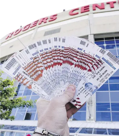  ??  ?? Scalpers outside Rogers Centre in Toronto are trying to sell tickets they purchased earlier for profit, the whole point of the enterprise, but sometimes fans can also find deals they may not get from the box office.