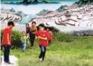  ?? PHOTOS BY WANG JING / CHINA DAILY ?? From top: Farmers work in the terrace rice fields in Dayutang village, Honghe prefecture, Yunnan province. The Hani rice terraces are a UNESCO World Heritage site. Children play in Azheke village, Honghe prefecture, Yunnan province.