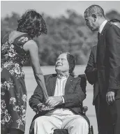  ??  ?? Former President George H.W. Bush greets President Barack Obama and wife Michelle as they arrive at Interconti­nental Airport in 2014. Brendan Smialowski/AFP/Getty Im