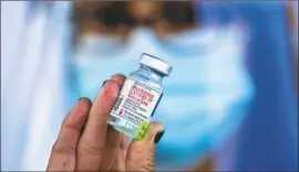  ?? Allen J. Schaben Los Angeles Times ?? NURSE Sandra Perez holds a vial of vaccine in Anaheim in January. Blue Shield’s role as overseer of the state’s COVID-19 vaccine providers has raised questions.