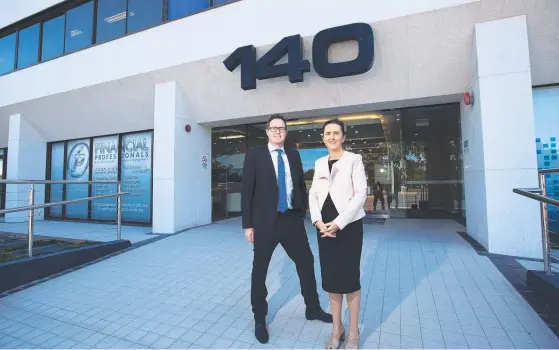  ?? Picture: AAP IMAGE ?? Tim Elliott and Nicole Anderson from Bell Legal Group outside their new building at 140 Bundall Rd, Bundall.