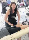  ??  ?? ●● Sports massage therapist, Elisa Connor, taking care of runners