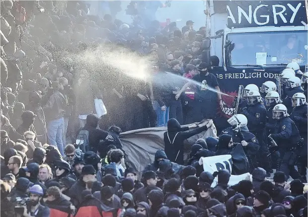  ?? THOMAS LOHNES / GETTY IMAGES ?? Police use water cannon and pepper spray against demonstrat­ors in Hamburg attending the “Welcome to Hell” anti- G20 protest on Thursday.
