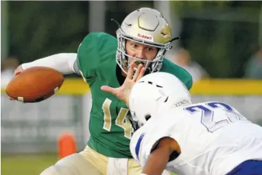  ?? STAFF PHOTOS BY C.B. SCHMELTER ?? Notre Dame’s Landon Allen, left, tries to get away from Central’s Gavin Spotts on Friday night at Notre Dame’s Jim Eberle Field.