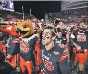  ?? Rick Bowmer Associated Press ?? RECEIVER SAMSON NACUA (45) and teammates let it be known that Utah defeated Oregon 32-25.