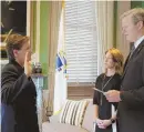  ?? PHOTO COURTESY GOVERNOR'S OFFICE ?? ‘ALL POSITIVE’: Gov. Charlie Baker swears Kerry Gilpin in as superinten­dent of the state police.