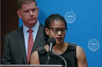  ?? Herald staff file ?? REFORM MOVEMENT: City Councilor Lydia Edwards speaks as Mayor Martin Walsh looks on. Walsh says he’ll sign a bill introduced by Edwards to overhaul the ZBA. The bill would then require Beacon Hill approval.