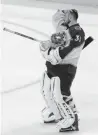  ?? The Associated Press ?? Avalanche goalie Philipp Grubauer wipes his head after a timeout in the third period.