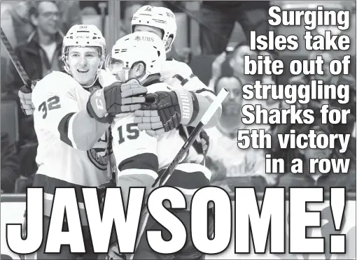  ?? AP ?? MAC ATTACK: Islanders center Kyle MacLean (left) is congratula­ted by right wing Cal Clutterbuc­k (right) and left wing Matt Martin after scoring a second-period goal against the Sharks on Thursday night in San Jose, Calif..