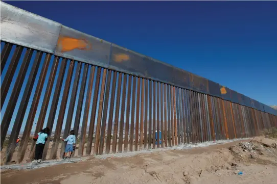  ??  ?? CHILDREN PLAY at a newly built section of the US-Mexico border wall at Sunland Park, New Mexico, opposite the Mexican border city of Ciudad Juarez, last year.