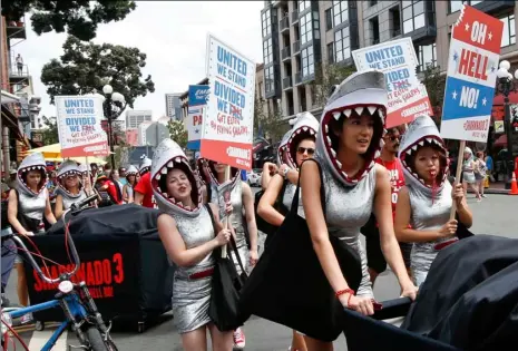  ?? AP PHOTO ?? In this July 9, 2015, file photo, women dressed as sharks march down the main street of the Gas Lamp District on opening day of the Comic-Con Internatio­nal convention in San Diego.