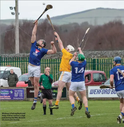  ??  ?? Wicklow’s Padraig Doyle and Andy O’Brien contest a high ball during the NHL Division 2A clash with Antrim.