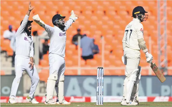  ?? AFP ?? India captain Virat Kohli, left, and wicketkeep­er Rishabh Pant successful­ly appeal for the wicket of England batsman Jack Leach during the fourth Test on Thursday