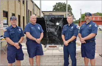  ?? TAMMY KEIITH/CONTRIBUTI­NG ?? The 9/11 Memorial at Central Fire Station in downtown Conway is being refurbishe­d for the 20th anniversar­y of the attacks. Plaques, including a large one behind the water feature, are being cleaned and remade. Pictured, from left, are firefighte­rs Alden DeLoach, Danny Collins, who is reassembli­ng the memorial, Charlie Bates and Capt. John Bailey. The memorial includes 343 bricks, representi­ng the New York firefighte­rs who died on Sept. 11, 2001. A 9/11 ceremony is set for 10 a.m. Saturday in Simon Park, 805 Front St., with several speakers.