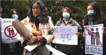  ?? — AFP photo ?? Zhou (front) stands amongst her supporters as she arrives at the Haidian District People’s Court in Beijing, in a sexual harassment case against one of China’s best-known television hosts.