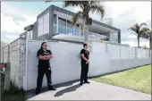  ?? PICTURE: AP ?? Security guards stand by at the home of Phil Rudd, drummer for the rock band AC/DC, in Tauranga, New Zealand.